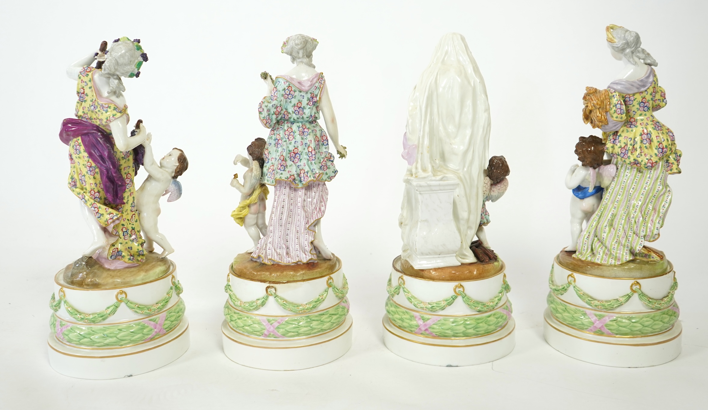 A set of four large Meissen style 'Four Seasons' groups and separate pedestals
